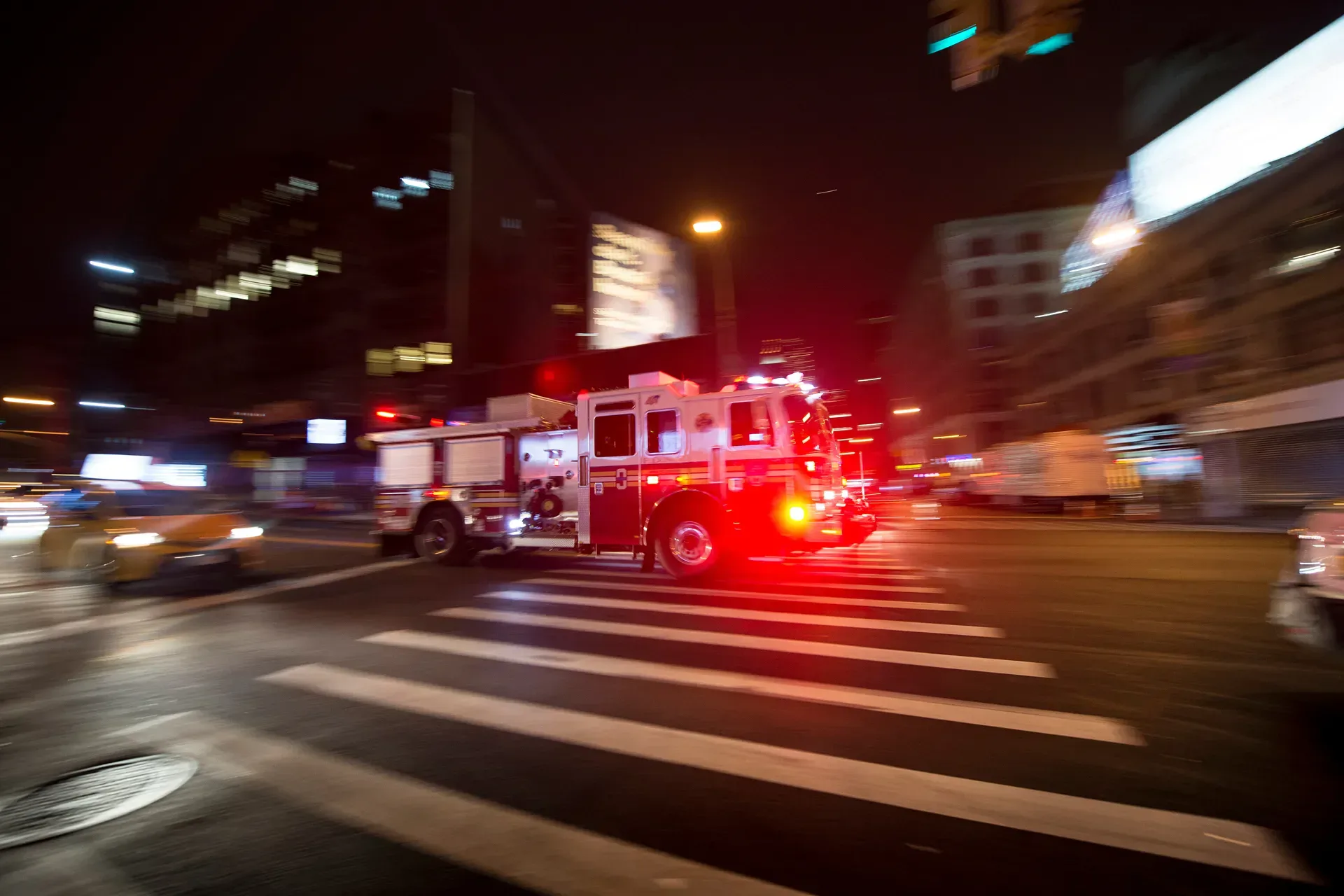Emergency vehicle stuck in traffic at night.